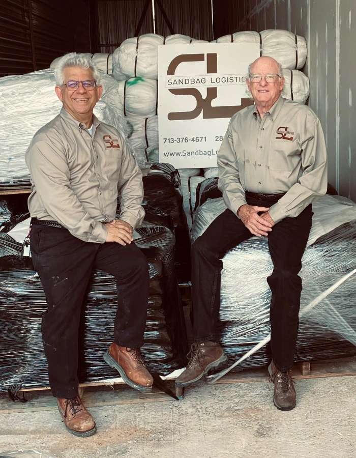Stu and Keith sitting on pallets in storage